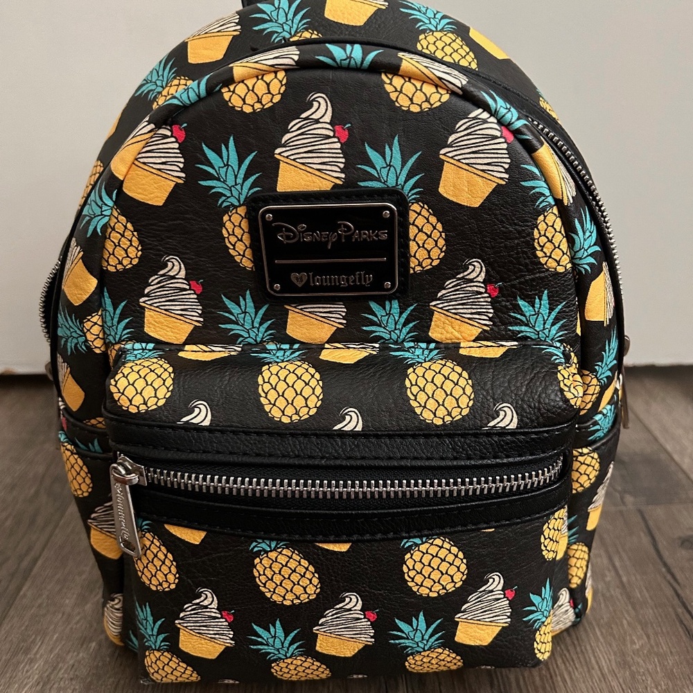 cute retired dole whip pineapple loungefly has 2 small spots on the pocket